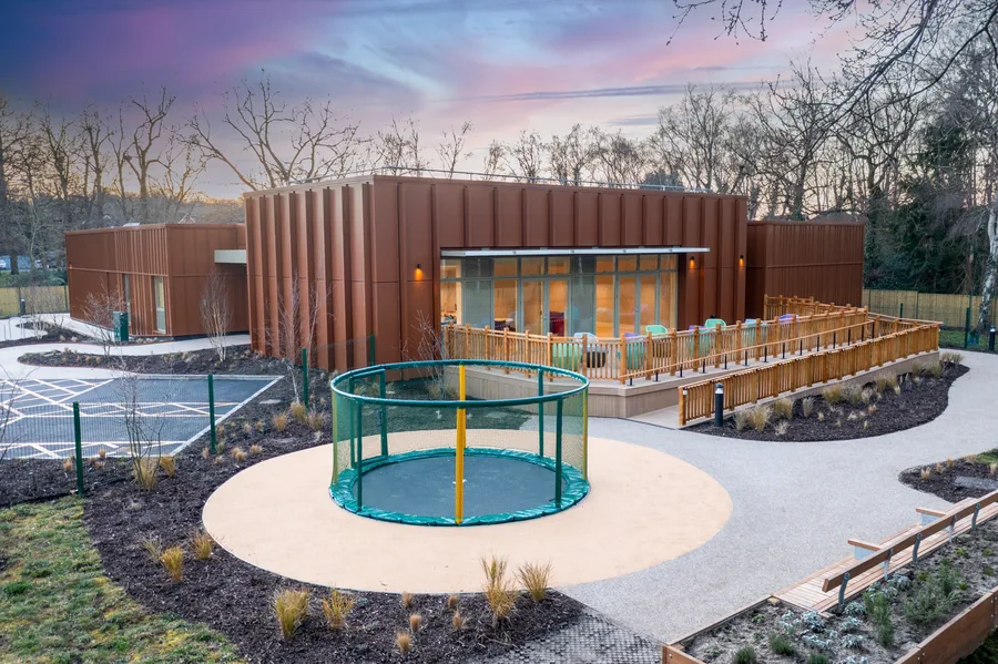 Respite centre exterior with copper-toned cladding at dusk